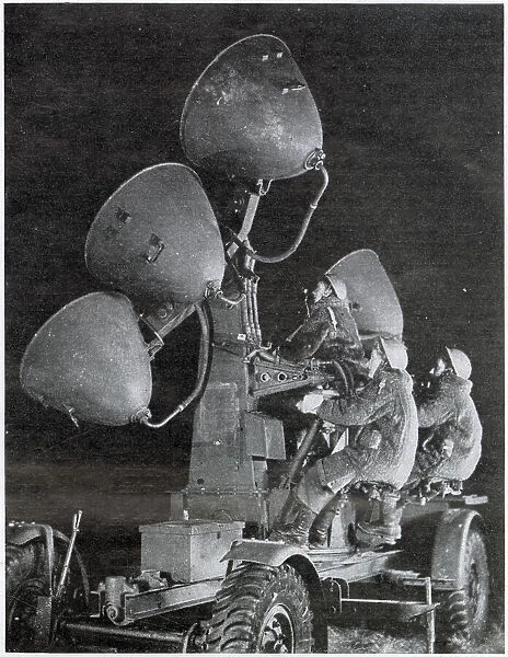 Auxiliary Territorial Service using search lights at night to spot on coming aircraft. Date: 1943