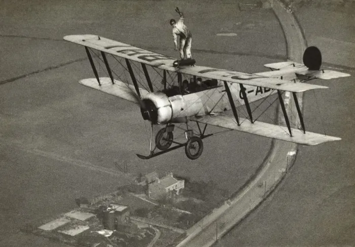 Framed Print : Avro 504K. Wing-Walking on an Avro 504K Flying over Fields Date: 1920s Framed Print : Avro 504K. Wing-Walking on an Avro 504K Flying over Fields Date: 1920s