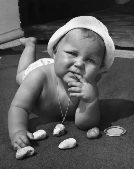 Framed Print : Baby playing with pebbles Framed Print : Baby playing with pebbles