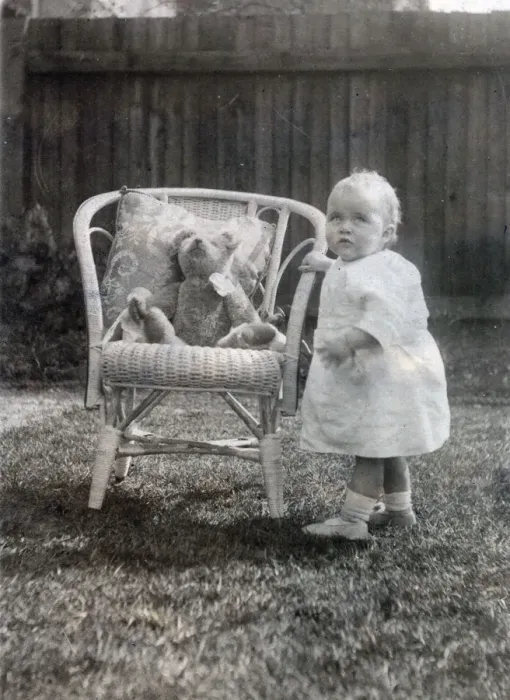 Framed Print : A baby toddles up to an elegant cane chair in her garden to say hello to her favourite Framed Print : A baby toddles up to an elegant cane chair in her garden to say hello to her favourite