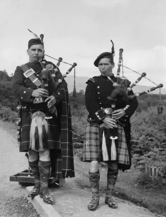 Framed Print : Two bagpipers on a road in the Trossachs, Scotland Framed Print : Two bagpipers on a road in the Trossachs, Scotland