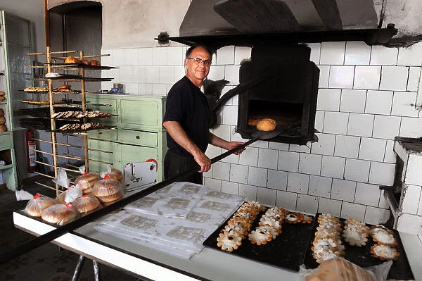 Baker Juan Olives bakes bread in olive wood burning oven