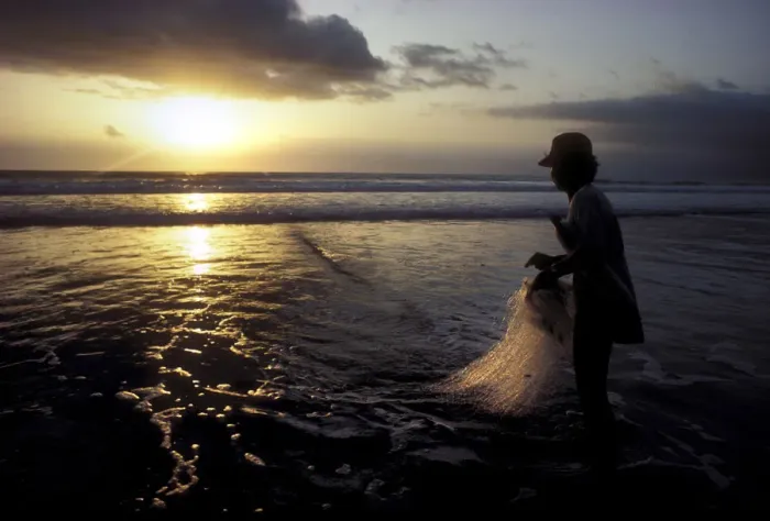Framed Print : A Balinese fisherman pauses to look at the sunset Framed Print : A Balinese fisherman pauses to look at the sunset