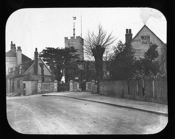 Barnett - View along road, houses and church