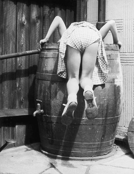 Barrel Girl. Bottoms up! A little girl accidentally reveals the fact that
