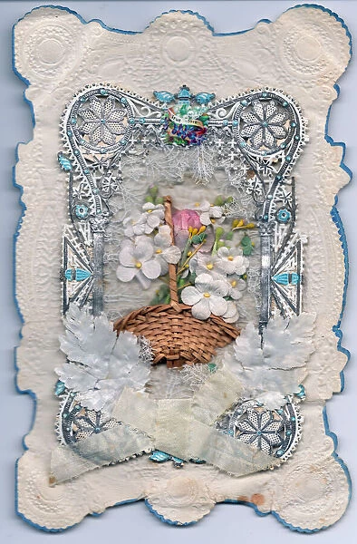 Basket of flowers on a paper lace greetings card