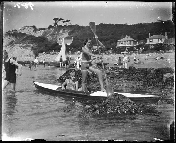Biarritz Canoers. Two girls paddling their canoe dangerously close to some