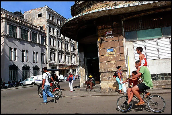 Bike and family in street, Havana, Cuba