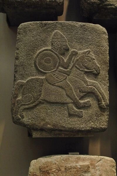 Black basalt relief depicting a soldier on a horse. Syria