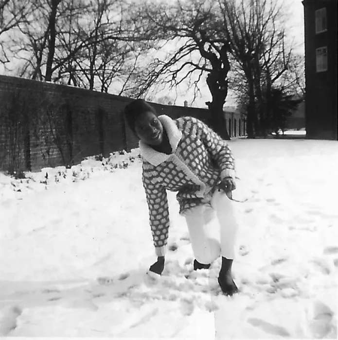 Framed Print : Black teenage girl touching and kneeling in the snow in Nott Framed Print : Black teenage girl touching and kneeling in the snow in Nott