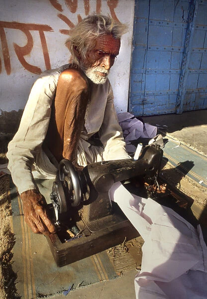A blind man working a sewing machine, Rajasthan, India