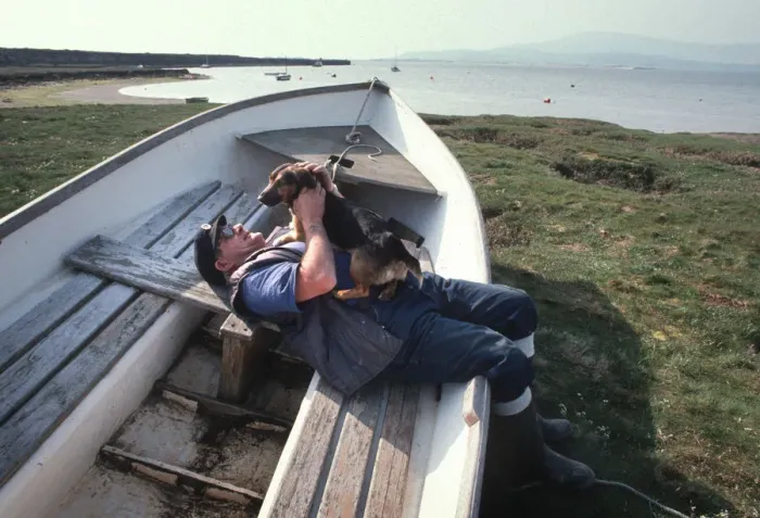 Framed Print : Boatman and dog on the saltings at Askam, near Barrow Framed Print : Boatman and dog on the saltings at Askam, near Barrow