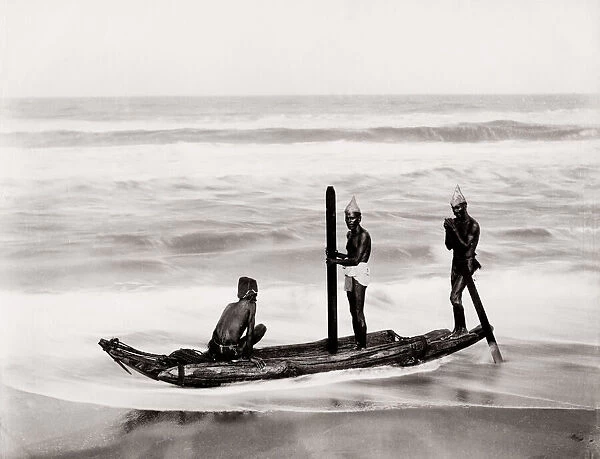 Boatmen on the sea on a traditional wood canoe