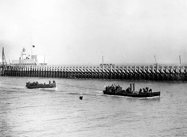 Boats containing British sailors near a pier, WW1