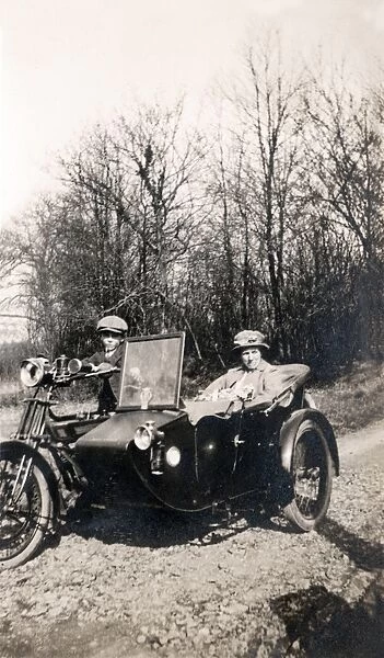 Boy on 1920 Royal Enfield motorcycle combination with passen