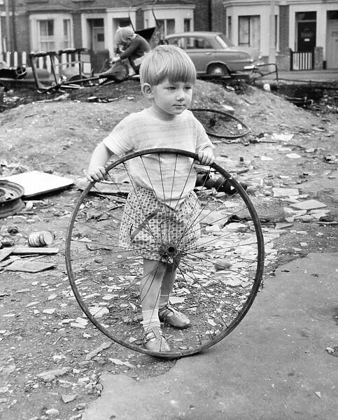Boy with bicycle wheel, Balham, SW London