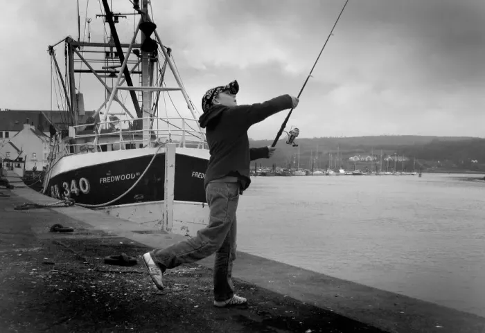 Framed Print : Boy casts his fishing line into River Dee at Kirkcudbright Framed Print : Boy casts his fishing line into River Dee at Kirkcudbright