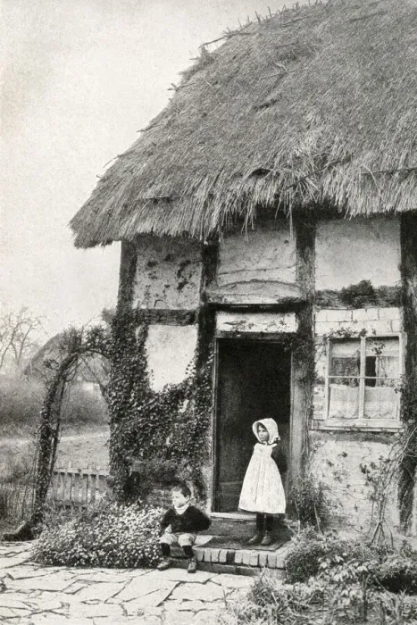 Framed Print : Boy and girl outside a thatched cottage, Worcestershire Framed Print : Boy and girl outside a thatched cottage, Worcestershire
