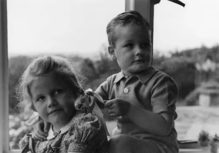 Framed Print : Boy and girl sitting in a window Framed Print : Boy and girl sitting in a window
