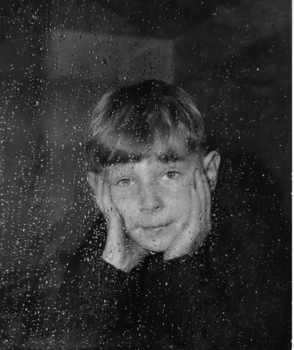 Framed Print : Boy looking through a window on a rainy day Framed Print : Boy looking through a window on a rainy day