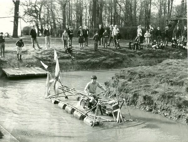 Boy operating pedal-driven drum raft