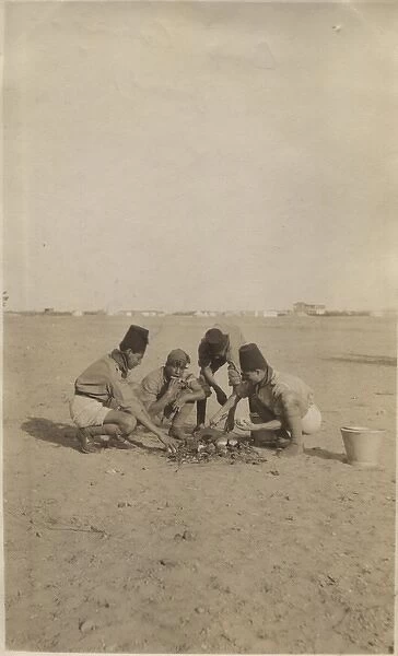 Boy scouts baking bread at camp, Cairo, Egypt