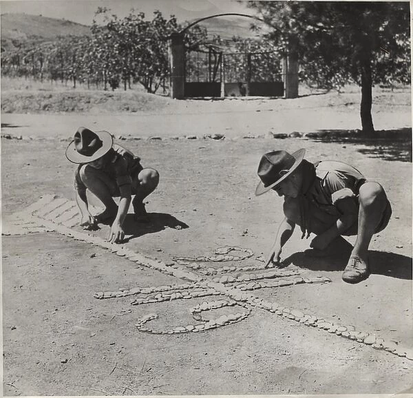 Boy scouts creating a design on the ground, Greece