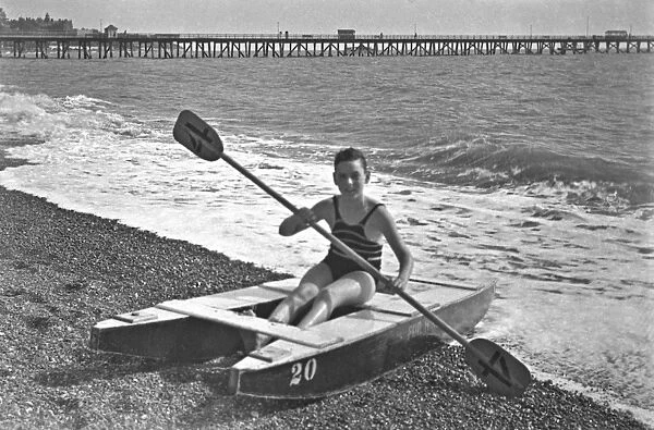Boy at the seaside on a raft