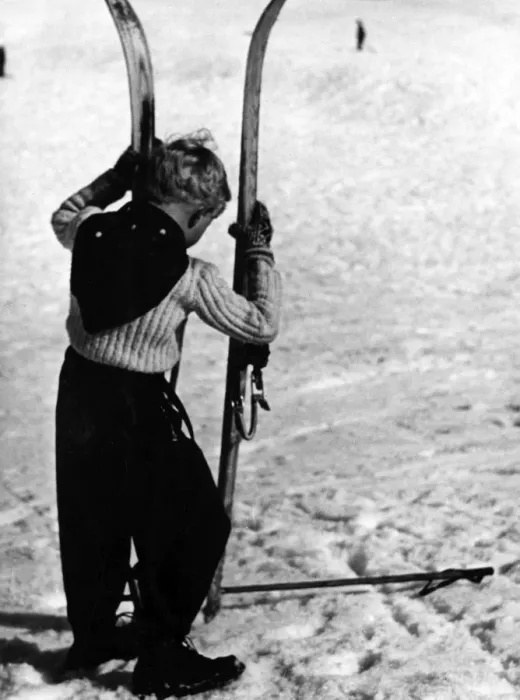 Framed Print : BOY SKIER. A little boy holding up a large pair of skis. Date: 1930s Framed Print : BOY SKIER. A little boy holding up a large pair of skis. Date: 1930s