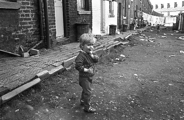 Boy in slum housing yard