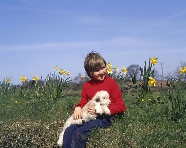 Boy with spring lamb and daffodils
