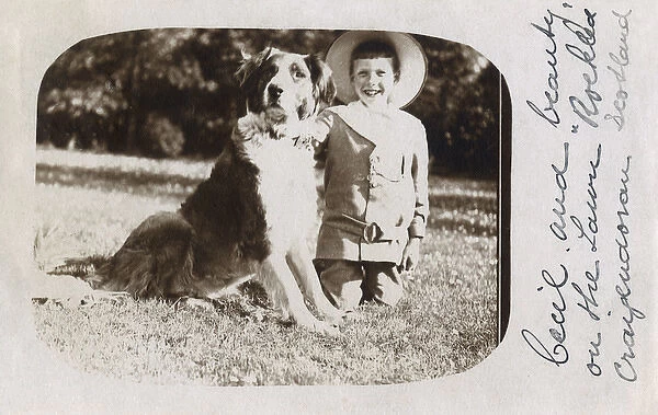 Boy in straw hat with large dog