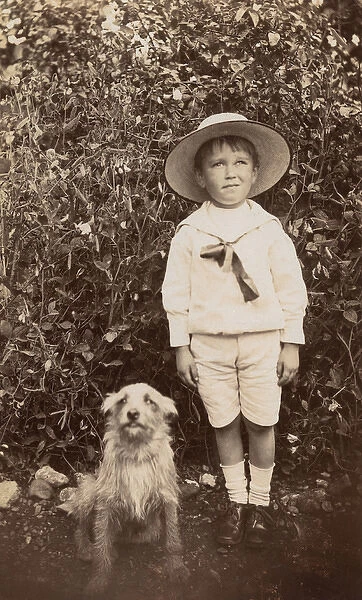 Boy with a terrier dog in a garden