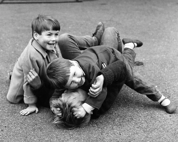 Three boys mock fighting, Balham, SW London