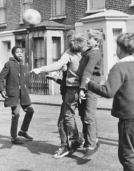 Boys playing football in a street, Balham, SW London