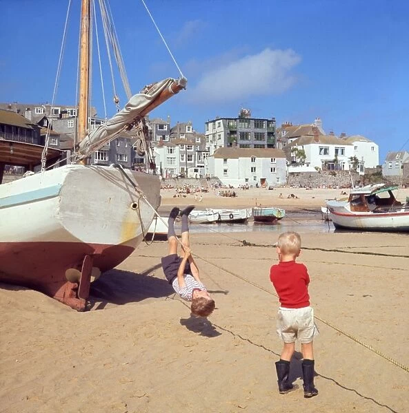 Two boys playing in the harbour, St Ives, Cornwall