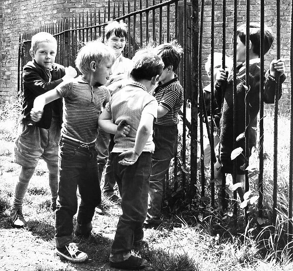 Boys playing by railings, Balham, SW London