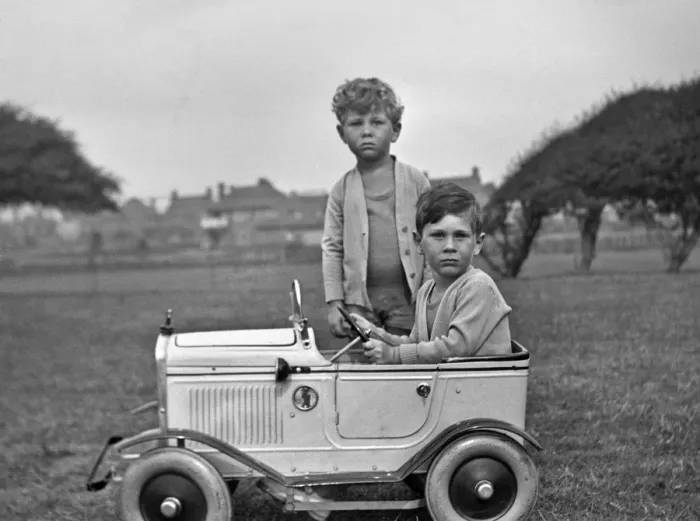 Framed Print : Two boys with toy car in a field Framed Print : Two boys with toy car in a field