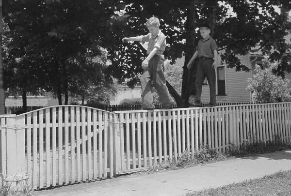 Boys walking fence. Washington, Indiana