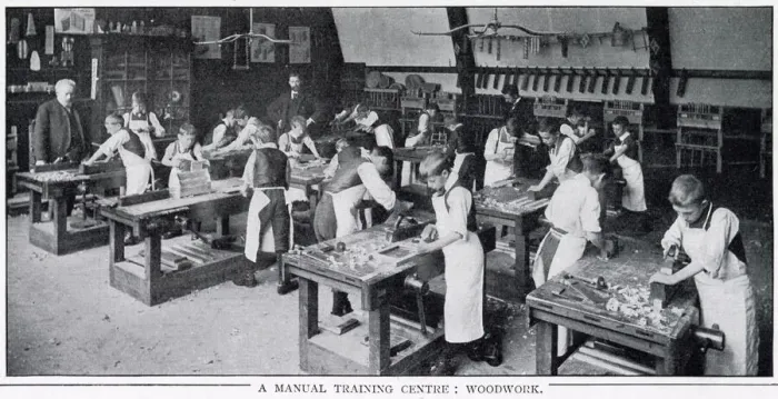Framed Print : Boys at workbenches learning how to use plane Framed Print : Boys at workbenches learning how to use plane
