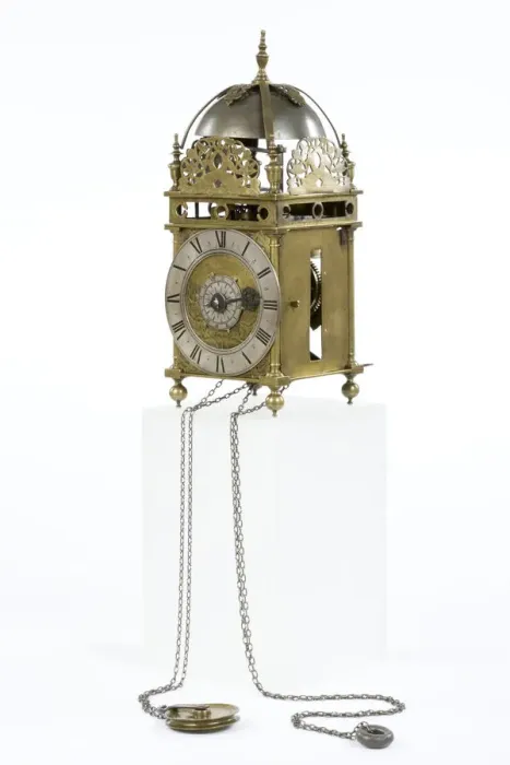Framed Print : Clock. Brass and metal lantern clock on four ball feet Framed Print : Clock. Brass and metal lantern clock on four ball feet