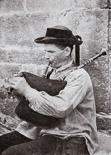 Breton musician playing bagpipes, Brittany, Northern France