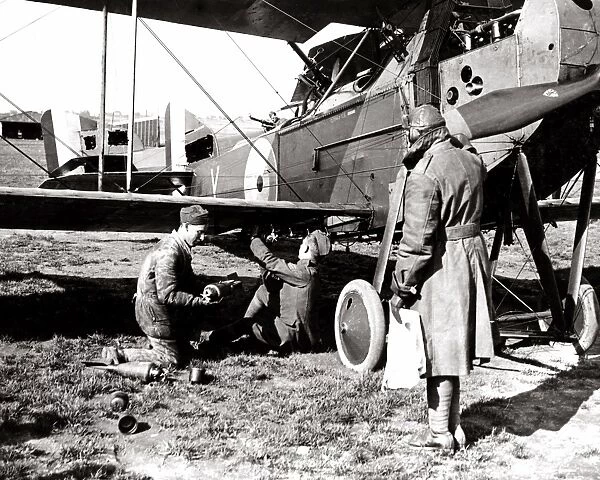 British airmen arming a plane with bombs, WW1