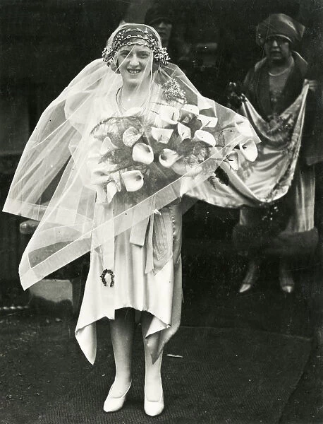 A British Bride with veil, bouquet and train