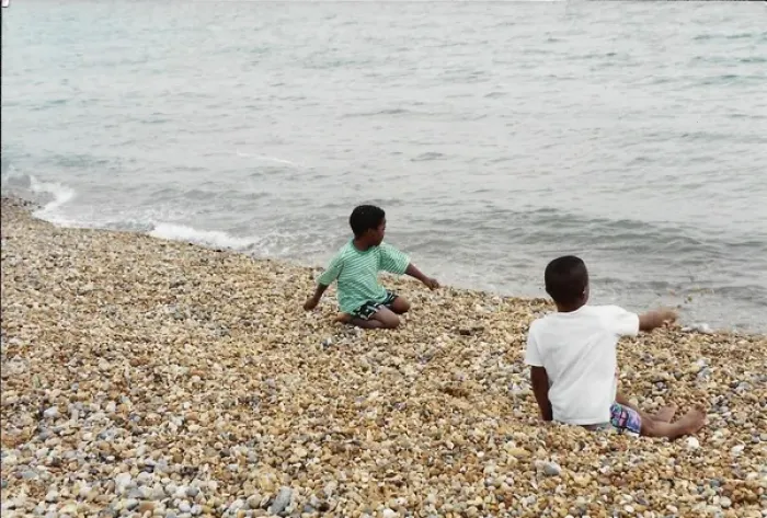 Framed Print : Two British Caribbean boys playing with stones on Brighton Framed Print : Two British Caribbean boys playing with stones on Brighton