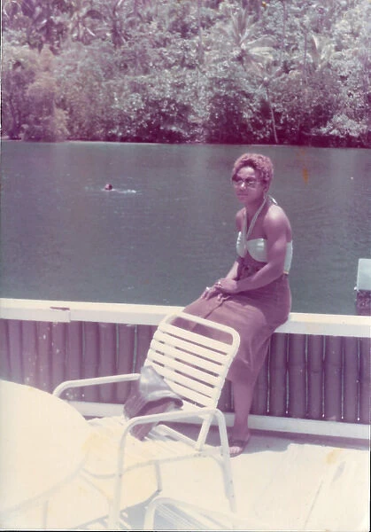 British Caribbean woman sitting by the Blue Lagoon in Port A