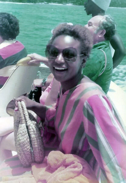 British Caribbean woman, sitting on boat crossing river, Ohi