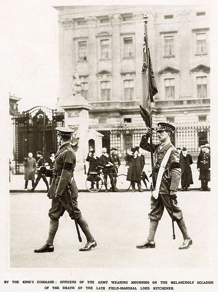 Two British officers of the Scots Guards bearing the Colour at the changing of the guard at Buckingham palace. The two soldiers are seen in black crepe armbands, as ordered by the King, following the death of Lord Kitchener (1850-1916)