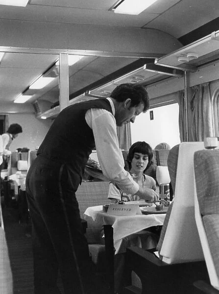 British Rail dining car, with waiter serving a passenger