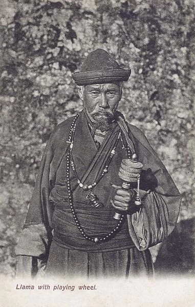 Buddhist Tibetan Lama holding a prayer wheel